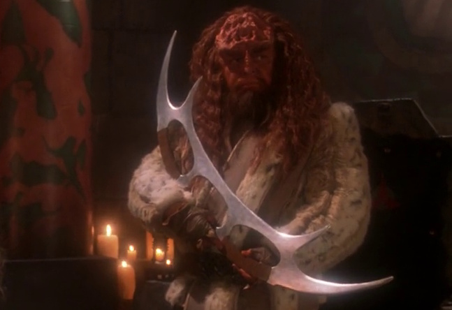 Still frame from Star Trek: The Next Generation showing a Klingon with a bat'leth.