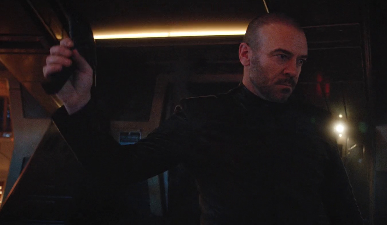 Still frame from Star Trek: Discovery Season 2 showing Captain Leland holding a phaser.