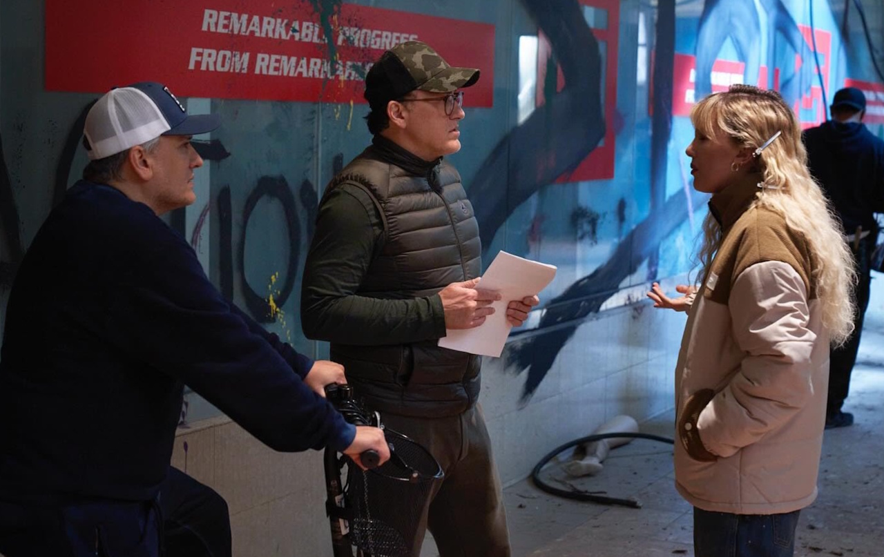 Behind-the-scenes photo from the set of The Electric State (2025) showing the Russo brothers and Millie Bobby Brown.