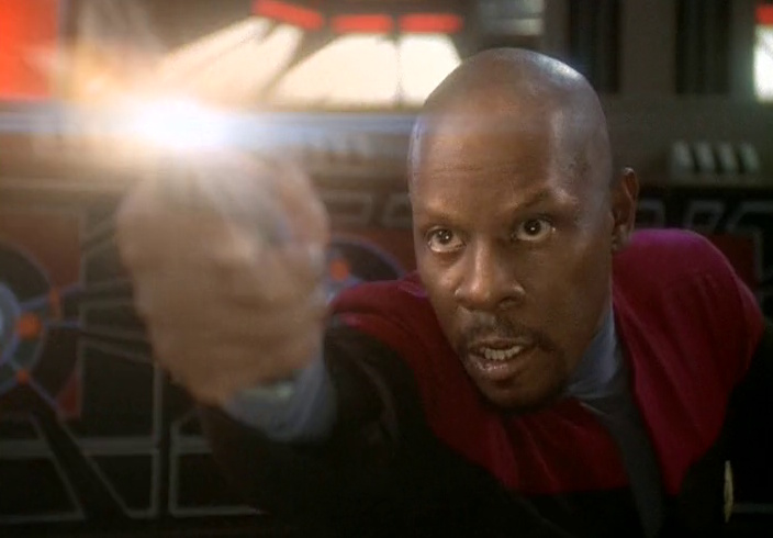 Still frame from Star Trek: Deep Space Nine showing Sisko firing a phaser.