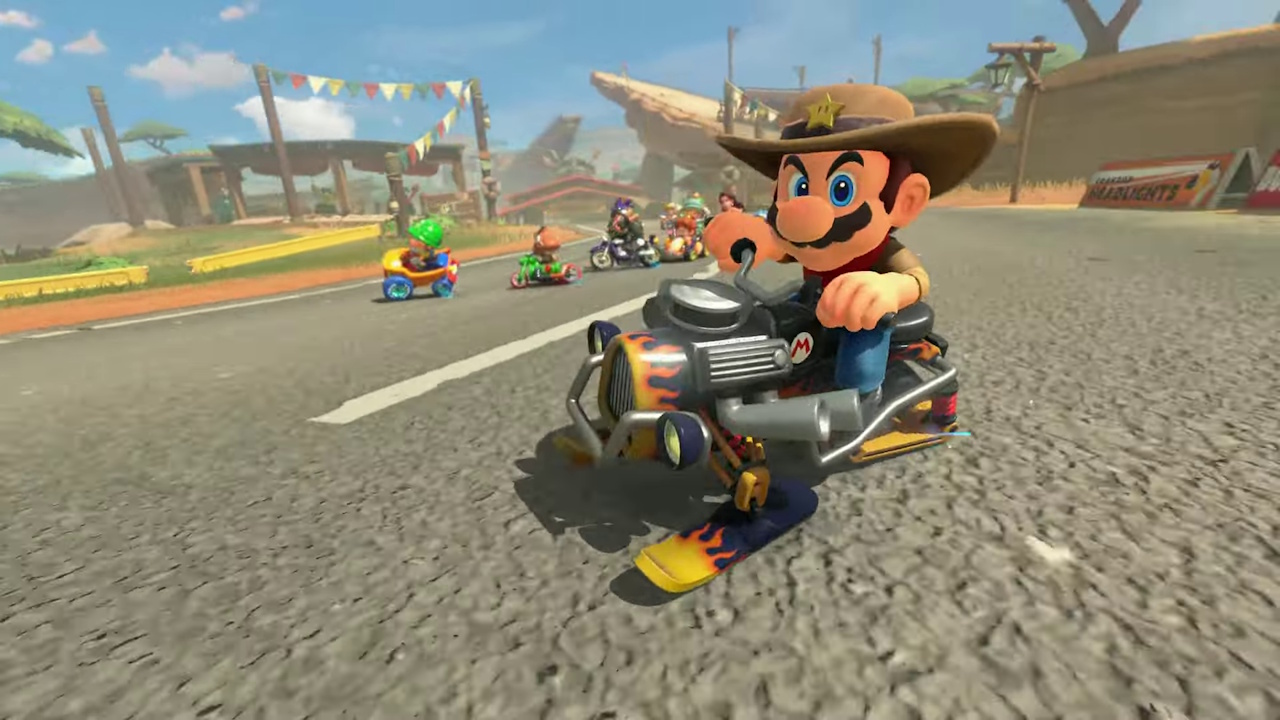 Promo still of Mario Kart World showing Mario on a snowmobile wearing a cowboy hat.