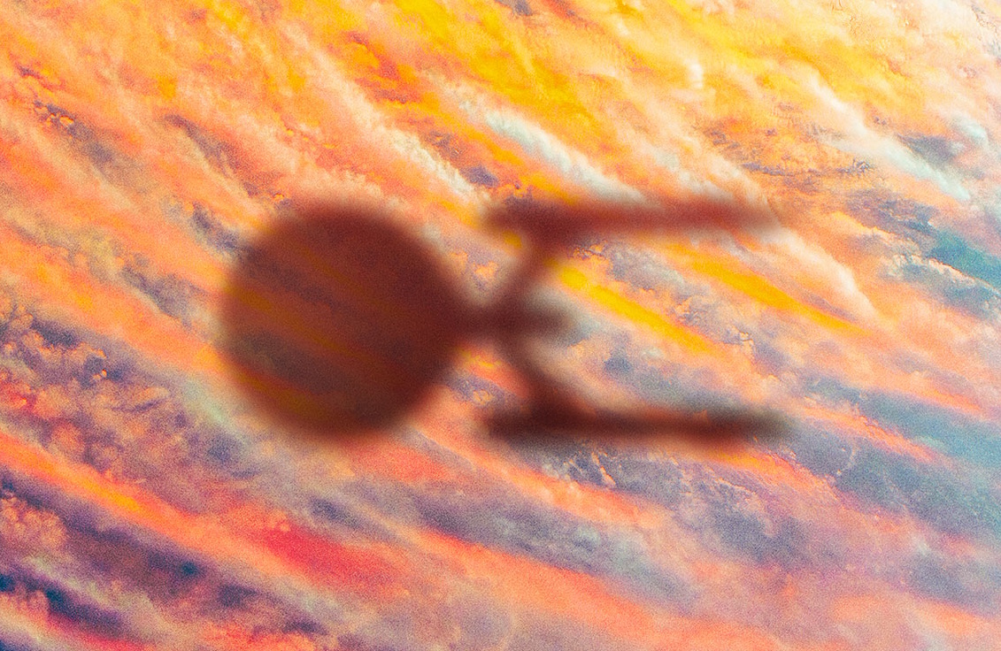 Cropped promotional poster for Star Trek: Strange New Worlds showing the shadow of the Enterprise.