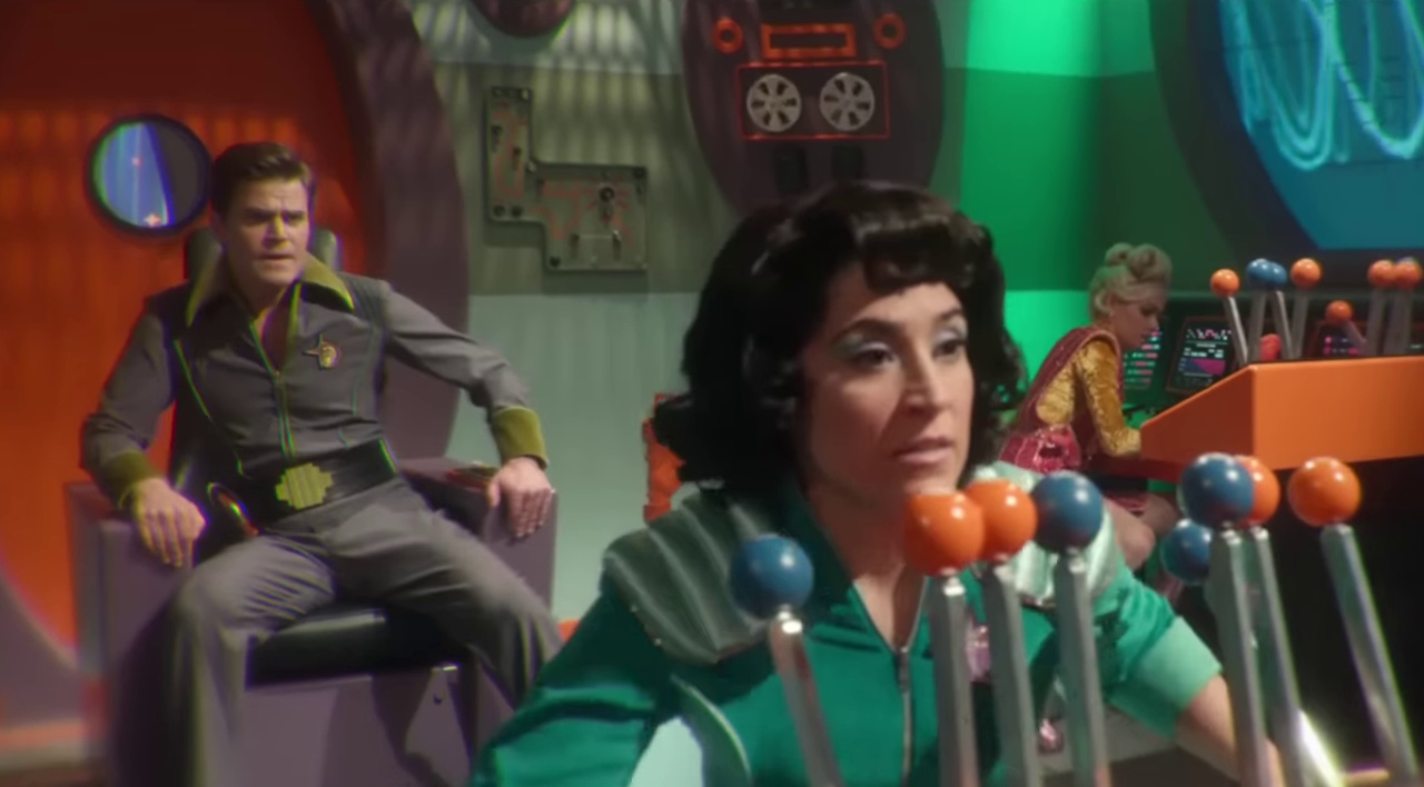 Still frame from the Star Trek: Strange New Worlds Season 3 trailer showing Kirk, Ortegas, and Chapel on the bridge of a spaceship.