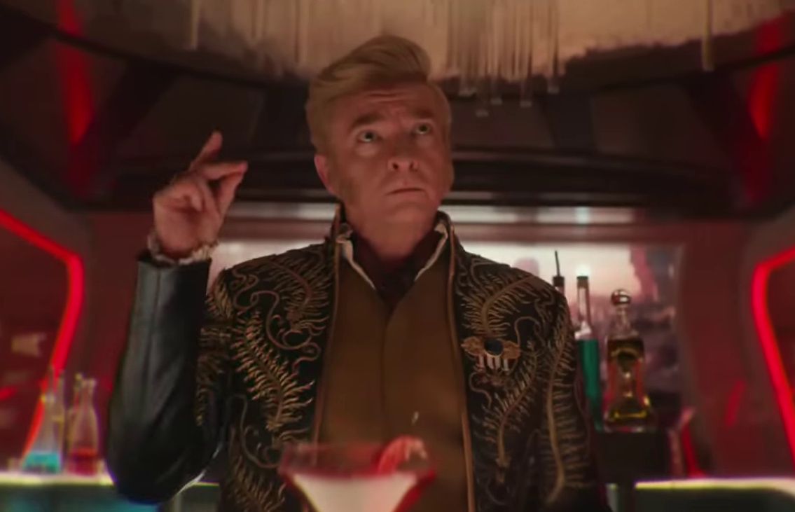 Still frame from the Star Trek: Strange New Worlds Season 3 trailer showing a man in an ornate coat snapping his fingers.