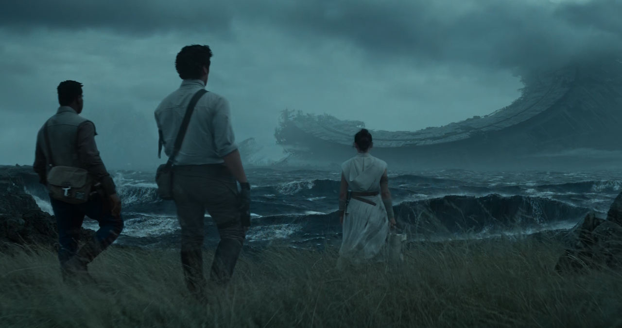 Still frame from Star Wars: The Rise of Skywalker (2019) showing Finn, Poe, and Rey with the wreck of the Death Star.