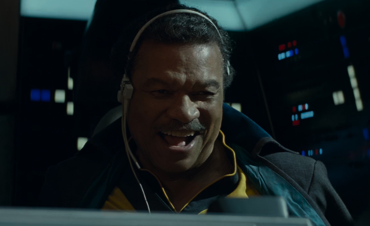 Still frame from Star Wars: The Rise of Skywalker (2019) showing Lando grinning aboard the Millennium Falcon.