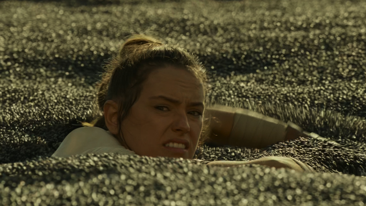 Still frame from Star Wars: The Rise of Skywalker (2019) showing Rey sinking in quicksand.