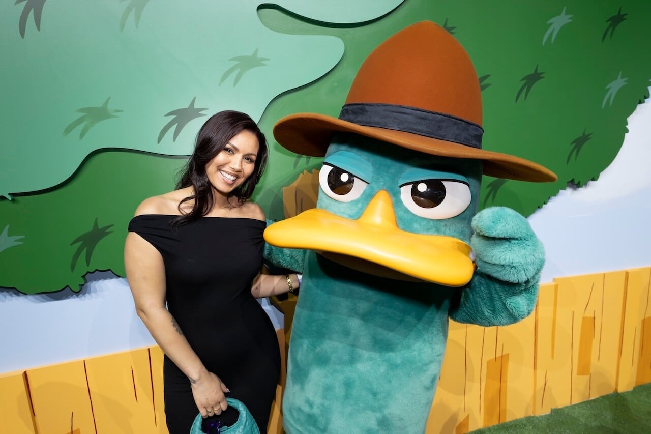 Photograph from the Phineas and Ferb S5 premiere showing Olivia Olson with a Perry the Platypus costumed figure.