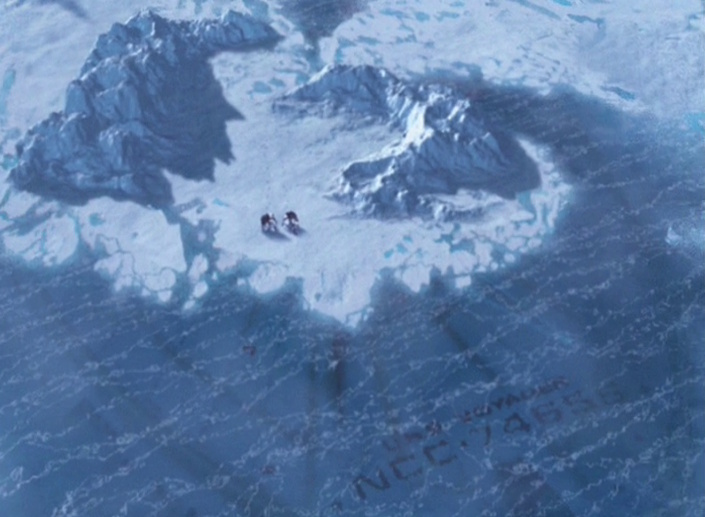 Still frame from Star Trek: Voyager showing Chakotay, Kim, and the icy wreck of the USS Voyager.