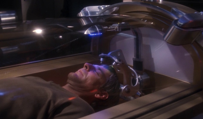Still frame from Star Trek: Enterprise showing Captain Archer laying in a medical machine.