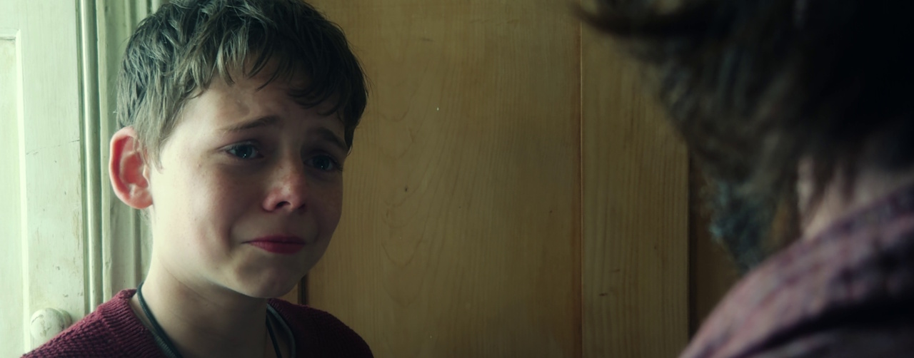 Still frame from 28 Years Later (2025) showing the confrontation between Spike and Jamie.