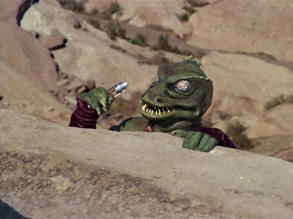 Still frame from Star Trek: The Original Series Season 1 episode Arena, showing the Gorn captain using a communicator.
