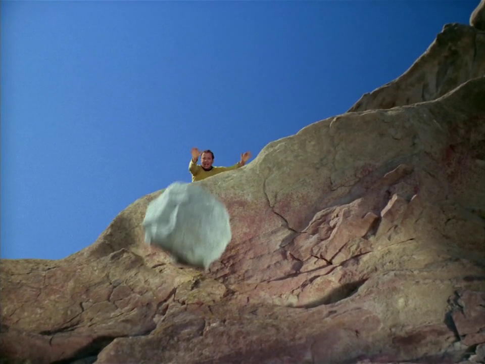 Still frame from Star Trek: The Original Series Season 1 episode Arena, showing Kirk and a boulder.