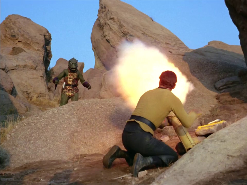 Still frame from Star Trek: The Original Series Season 1 episode Arena, showing Kirk firing his cannon at the Gorn captain.