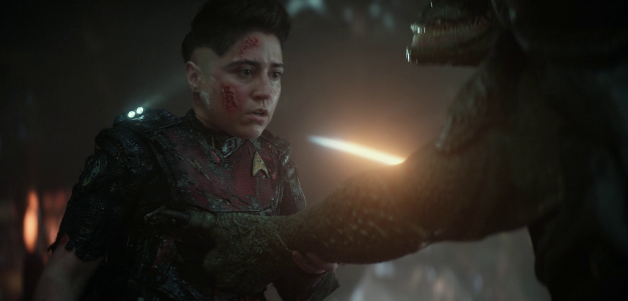 Still frame from Star Trek: Strange New Worlds 3x01: Hegemony, Part II, showing Ortegas losing a fight with a Gorn.
