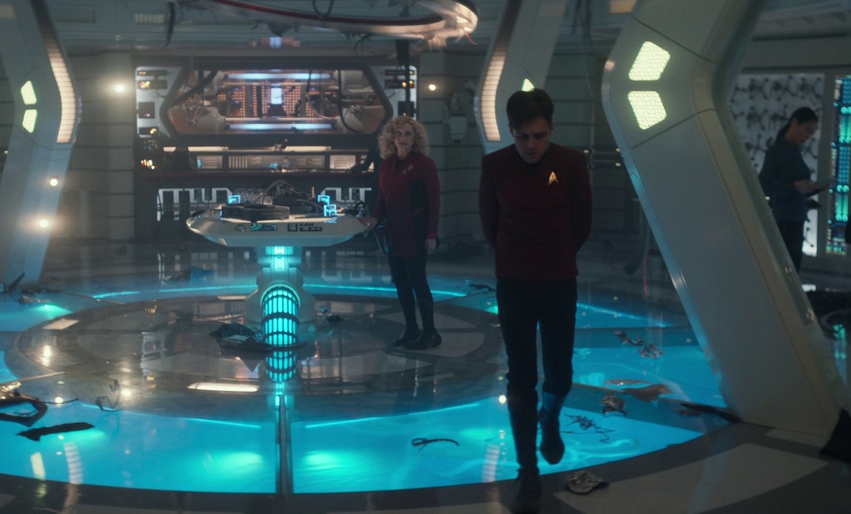 Still frame from Star Trek: Strange New Worlds 3x01: Hegemony, Part II, showing Scotty walking away from Pelia.