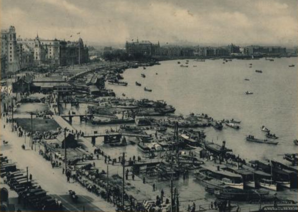 Photograph of Shanghai, circa 1927. Black-and-white image from an elevated position looking down on a waterfront packed with boats.