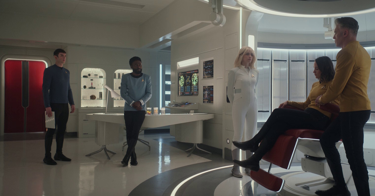 Still frame from Star Trek: Strange New Worlds 3x03: Shuttle to Kenfori, showing Spock, M'Benga, Chapel, Batel, and Pike in sickbay.