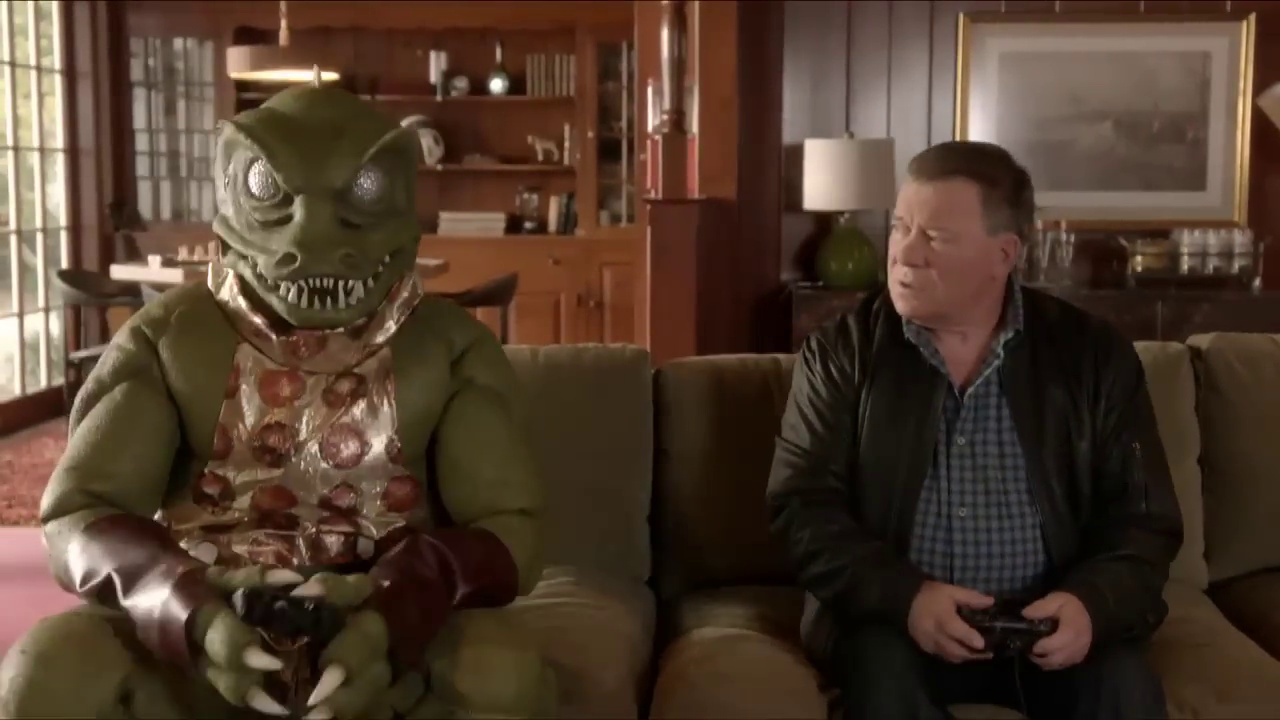 Still frame from a TV advert for the Star Trek video game circa 2013 showing William Shatner and someone in a Gorn costume.