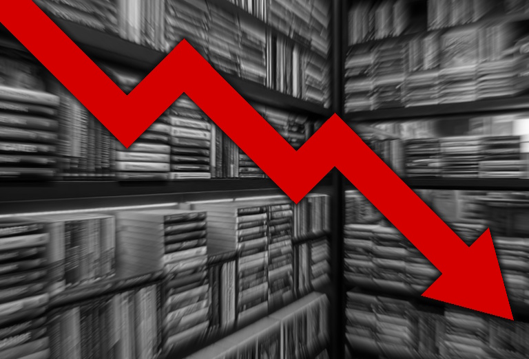 Black-and-white image of video games on shop shelves with a red "downwards" arrow superimposed on top.