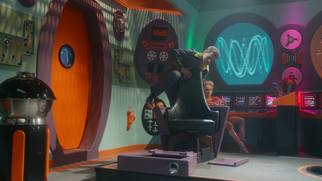 Still frame from Star Trek: Strange New Worlds 3x04 "A Space Adventure Hour," showing a blooper of Kirk breaking his chair.