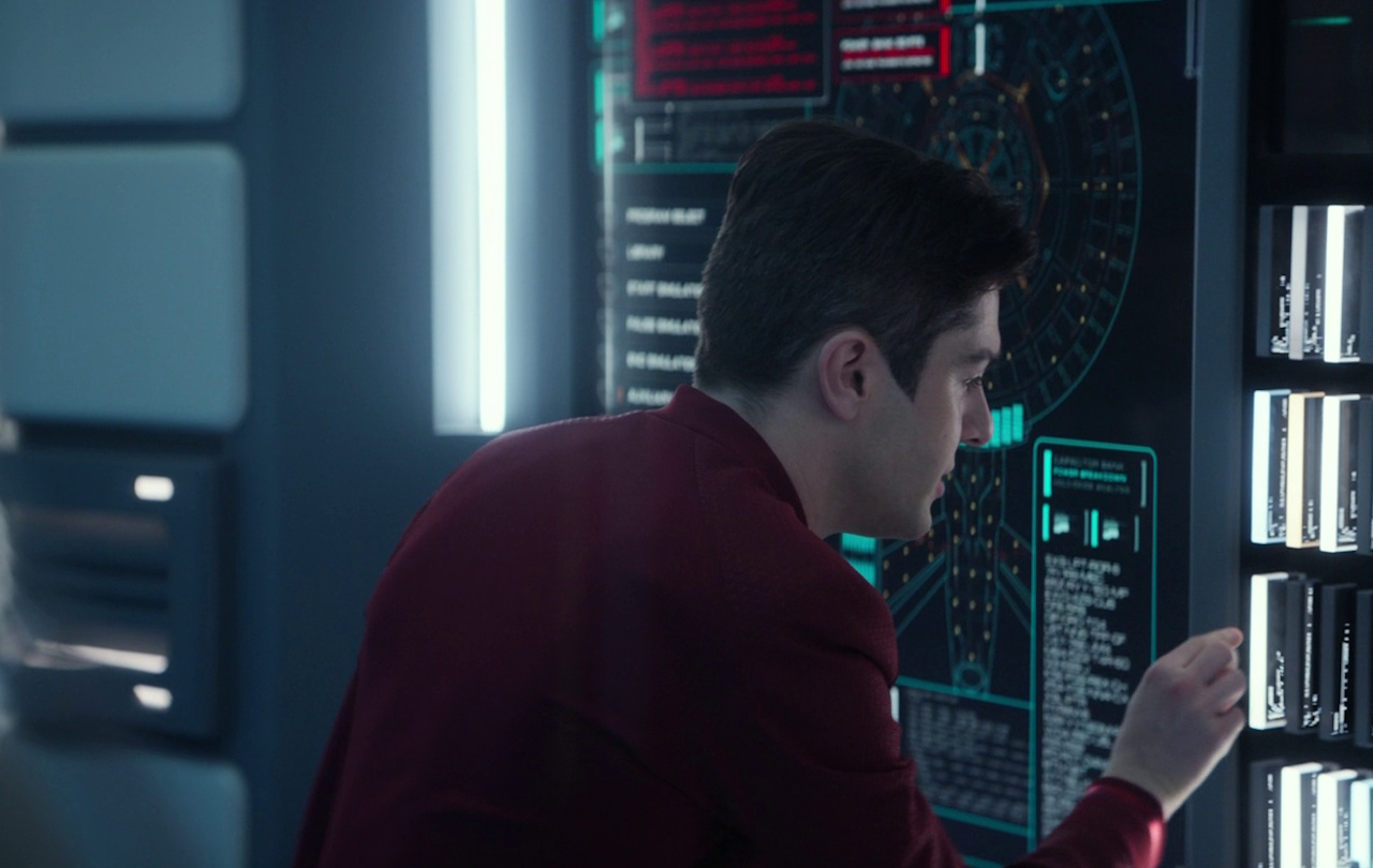 Still frame from Star Trek: Strange New Worlds 3x04 "A Space Adventure Hour," showing Scotty at work.