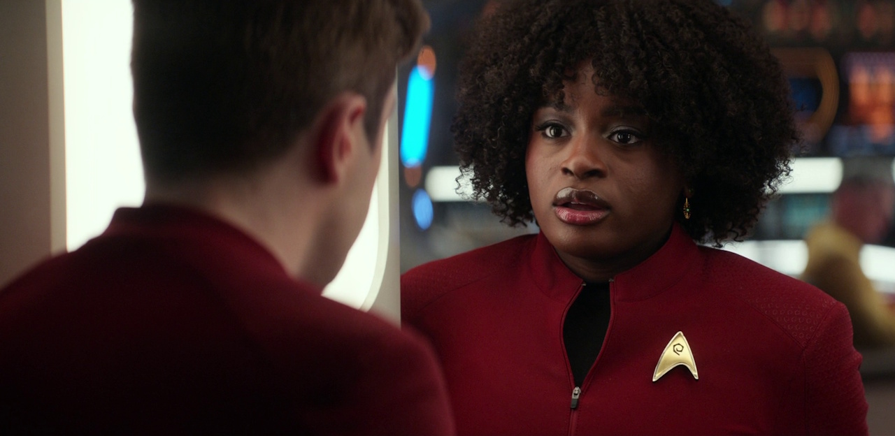 Still frame from Star Trek: Strange New Worlds 3x04 "A Space Adventure Hour," showing Scotty having a conversation with Uhura.