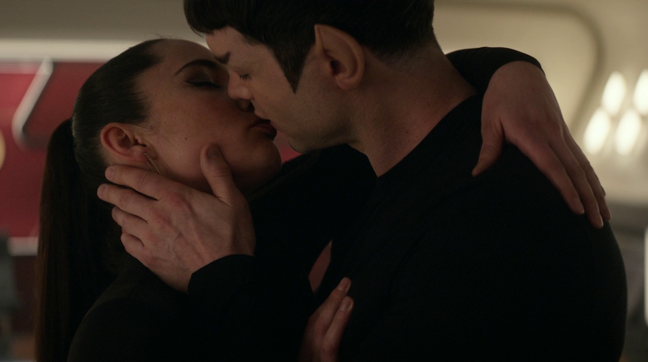Still frame from Star Trek: Strange New Worlds 3x04 "A Space Adventure Hour," showing La'an and Spock kissing.