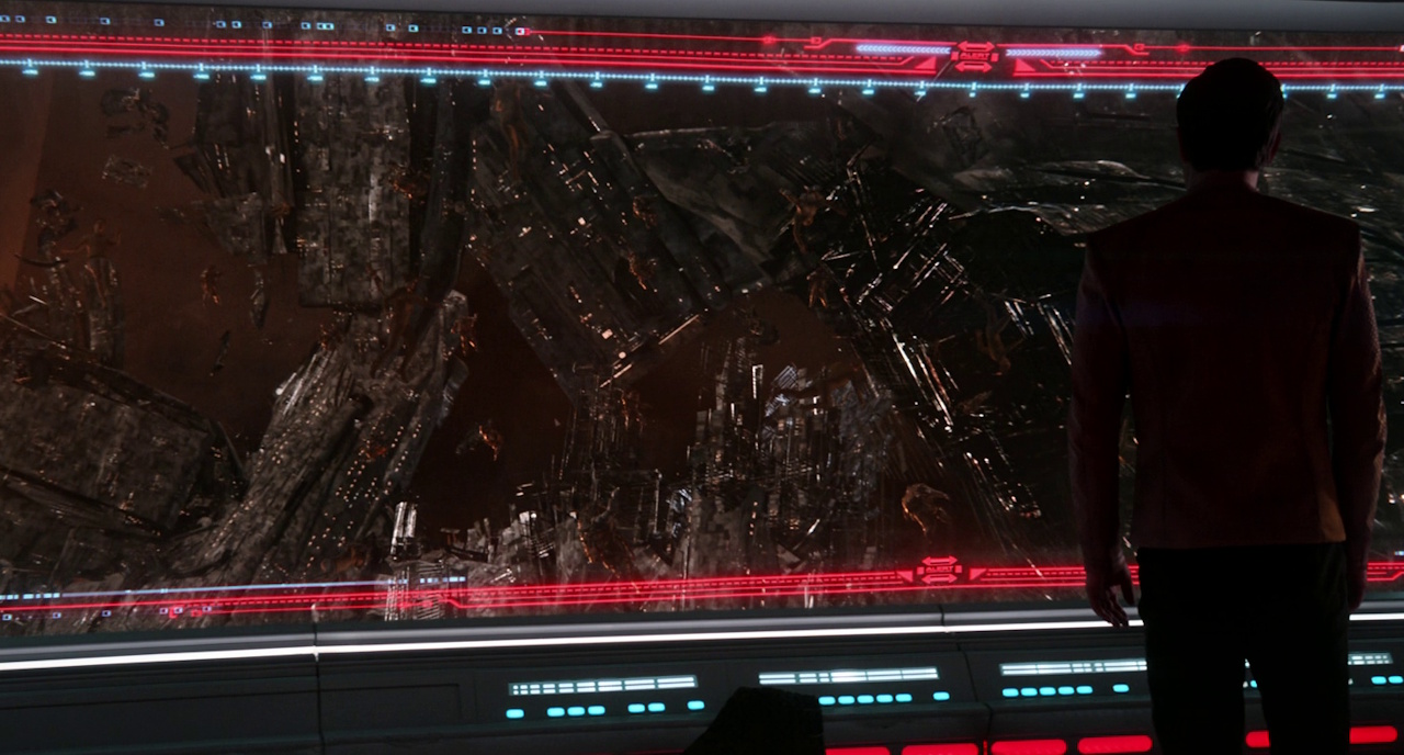 Still frame from Star Trek: Strange New Worlds 3x06: The Sehlat Who Ate Its Tail showing Kirk looking at the debris on the main viewscreen.