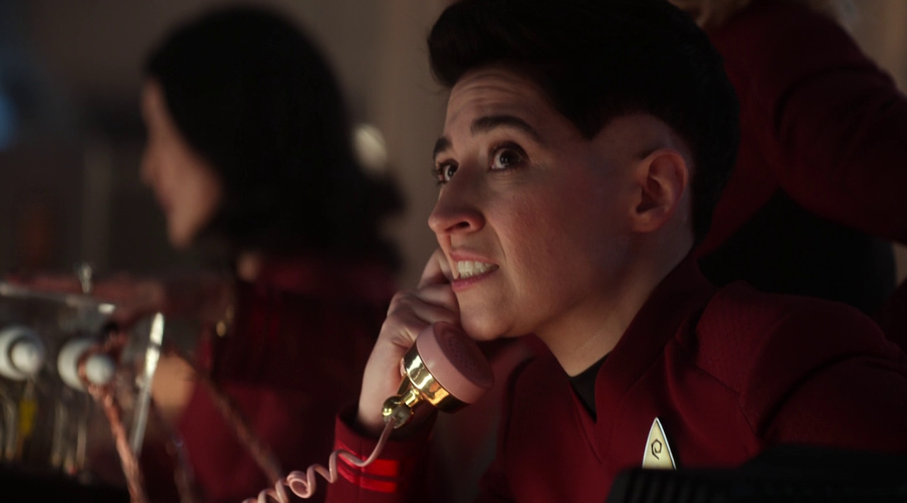 Still frame from Star Trek: Strange New Worlds 3x06: The Sehlat Who Ate Its Tail showing Ortegas on the telephone.