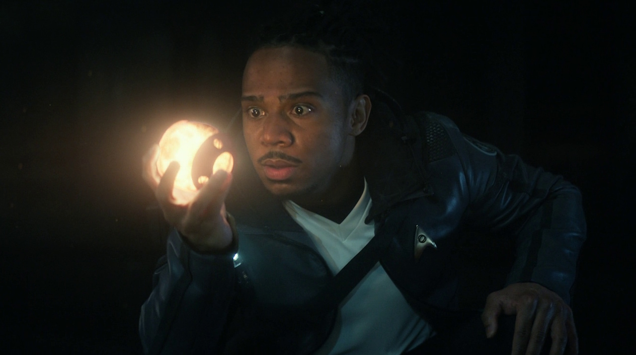 Still frame from Star Trek: Strange New Worlds 3x05 "Through the Lens of Time" showing Gamble holding a glowing orb.