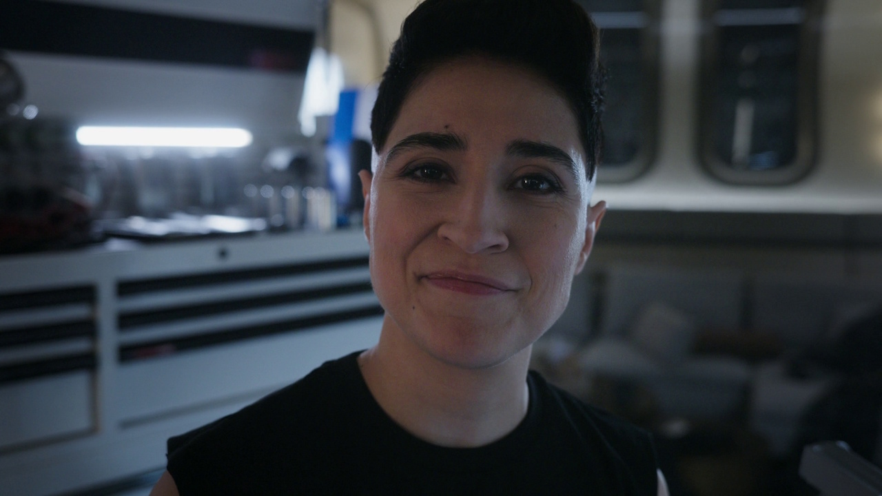 Still frame from Star Trek: Strange New Worlds S03E07 "What Is Starfleet?" showing Erica Ortegas smiling.