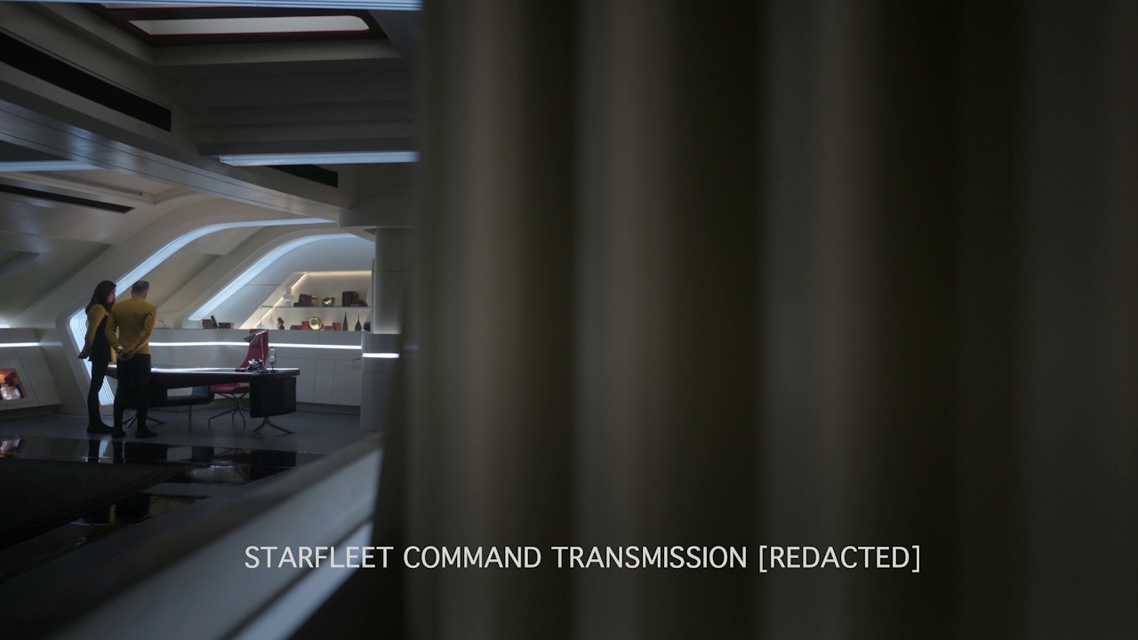 Still frame from Star Trek: Strange New Worlds S03E07 "What Is Starfleet?" showing Pike and Una conversing with Starfleet Command.