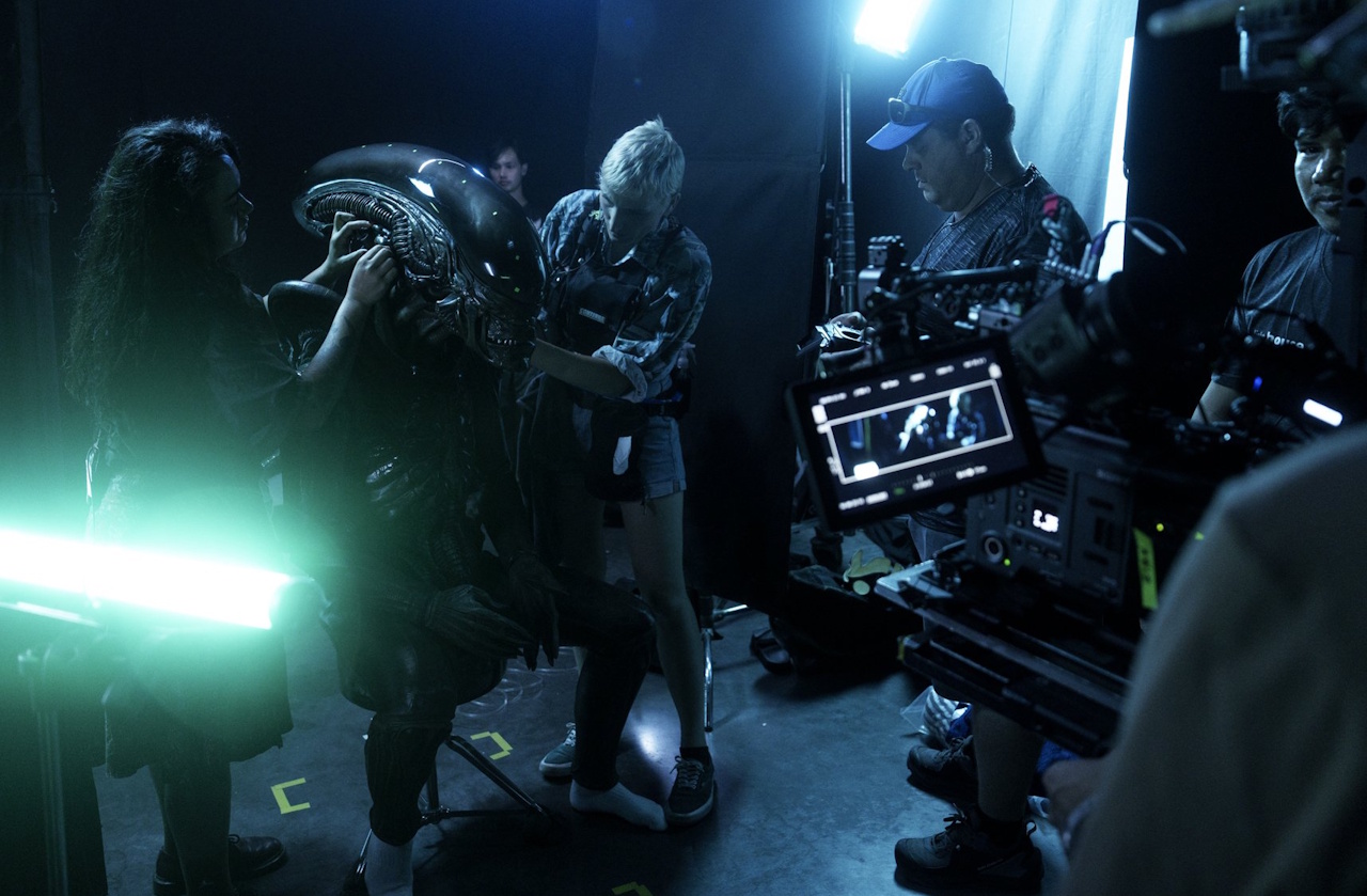 Behind-the-scenes photo from the set of Alien: Earth showing the Xenomorph being adjusted/touched up.