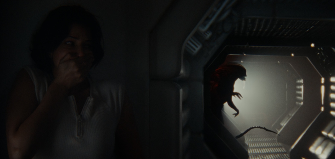 Still frame from Alien: Earth showing someone trying to hide from a Xenomorph.