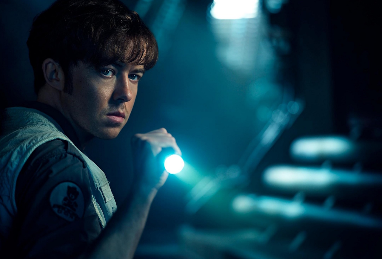 Promo photo for Alien: Earth (2025) showing Joe holding a torch.