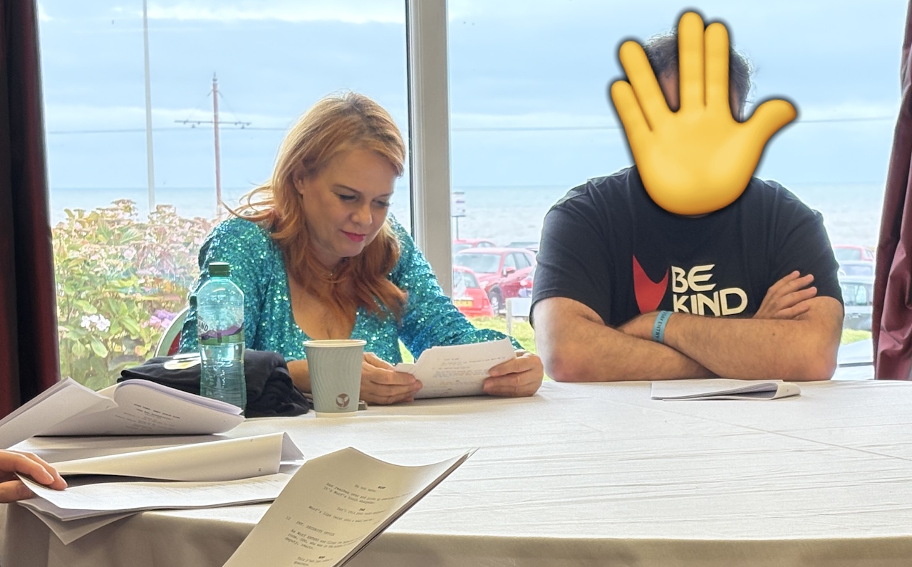 Photograph from Destination Star Trek 2025 showing Chase Masterson reading her script.