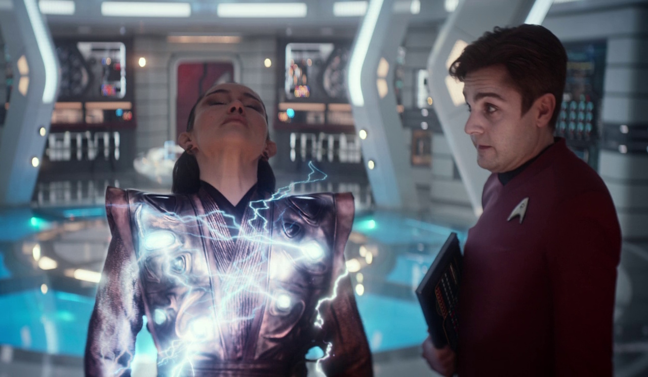 Still frame from Star Trek: Strange New Worlds, 3x08, Four-and-a-Half Vulcans showing Scotty stopping La'an.