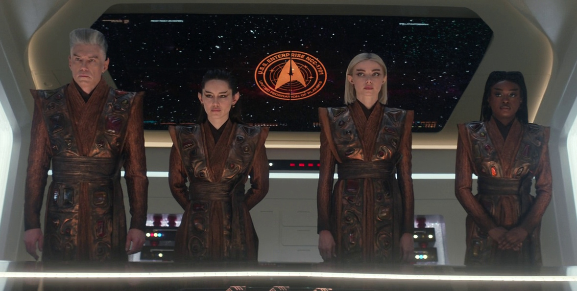 Still frame from Star Trek: Strange New Worlds, 3x08, Four-and-a-Half Vulcans showing four humans transformed into Vulcans.