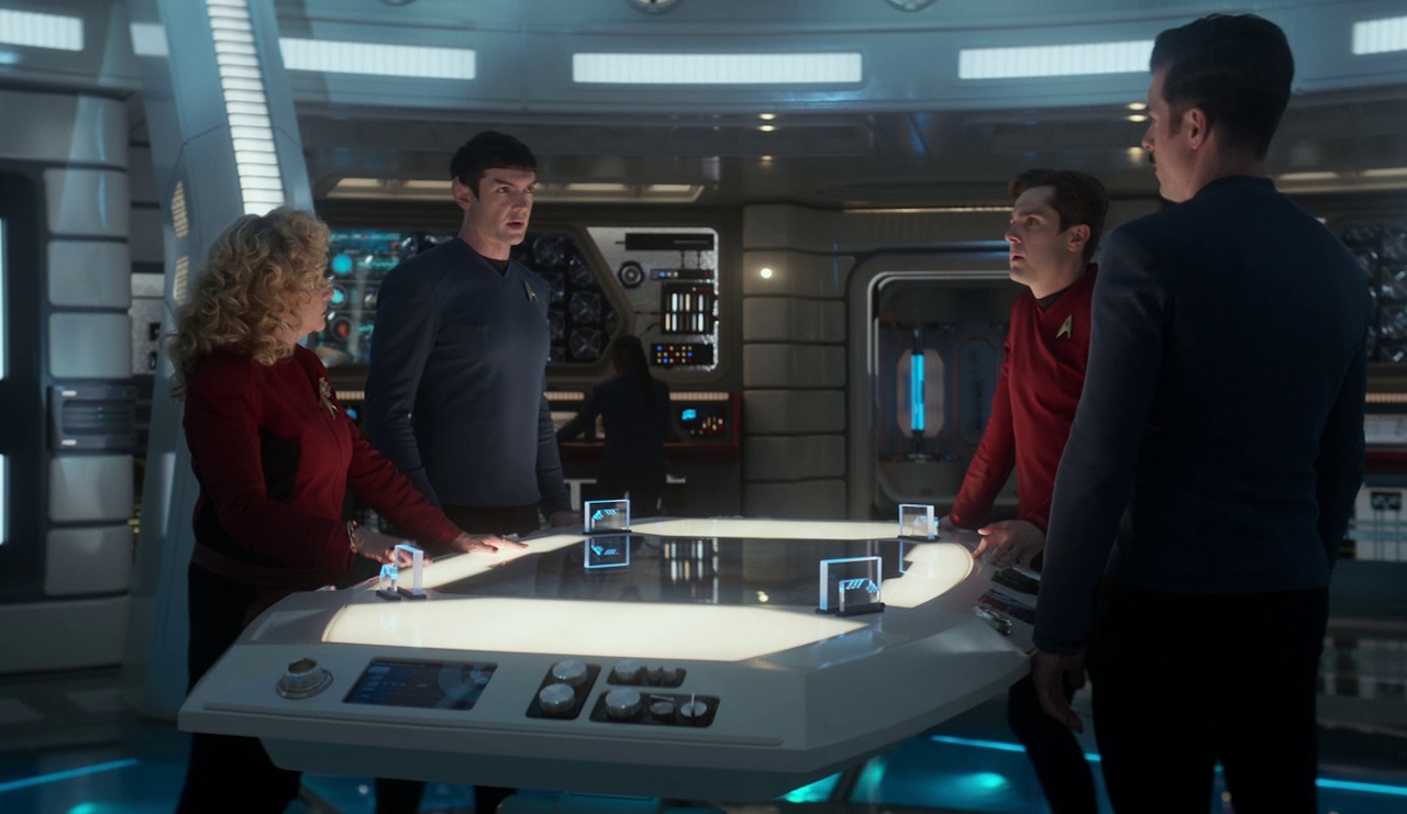 Still frame from Star Trek: Strange New Worlds 3x10 (New Life and New Civilizations) showing Pelia, Spock, Scotty, and Sam Kirk in the lab.