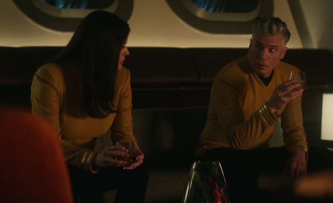 Still frame from Star Trek: Strange New Worlds 3x10 (New Life and New Civilizations) showing Una and Pike drinking together.