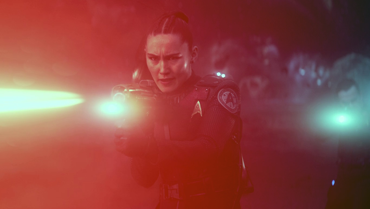 Still frame from Star Trek: Strange New Worlds 3x09: Terrarium, showing La'an firing her phaser rifle.