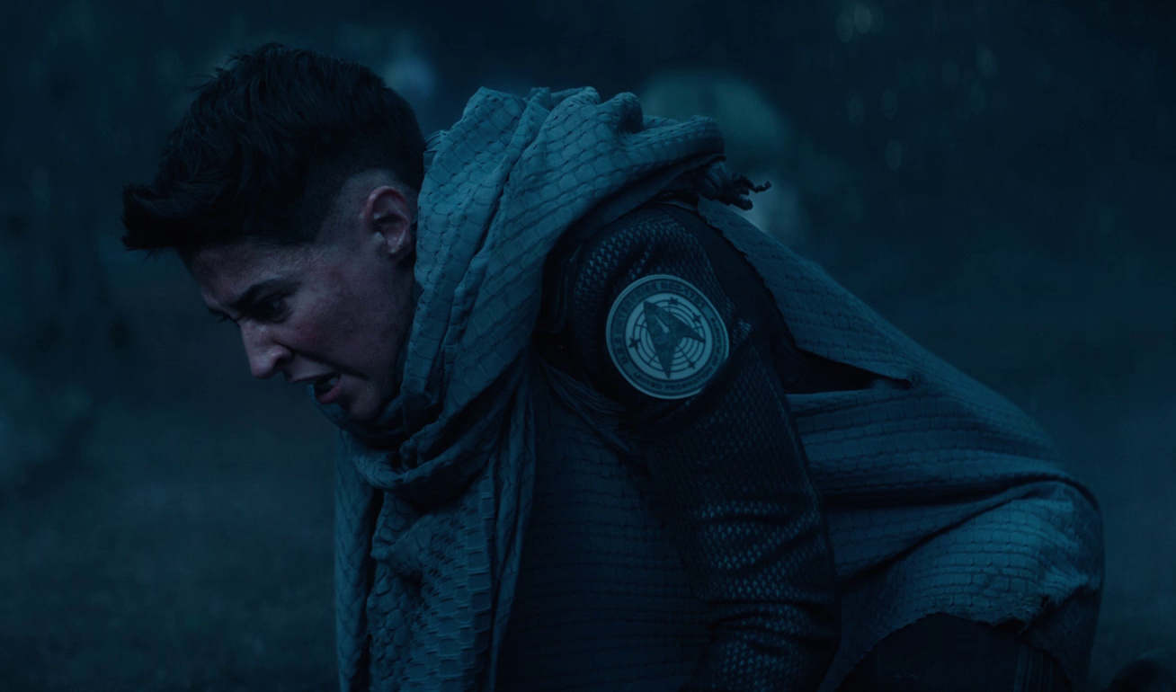 Still frame from Star Trek: Strange New Worlds 3x09: Terrarium, showing Ortegas on her knees.