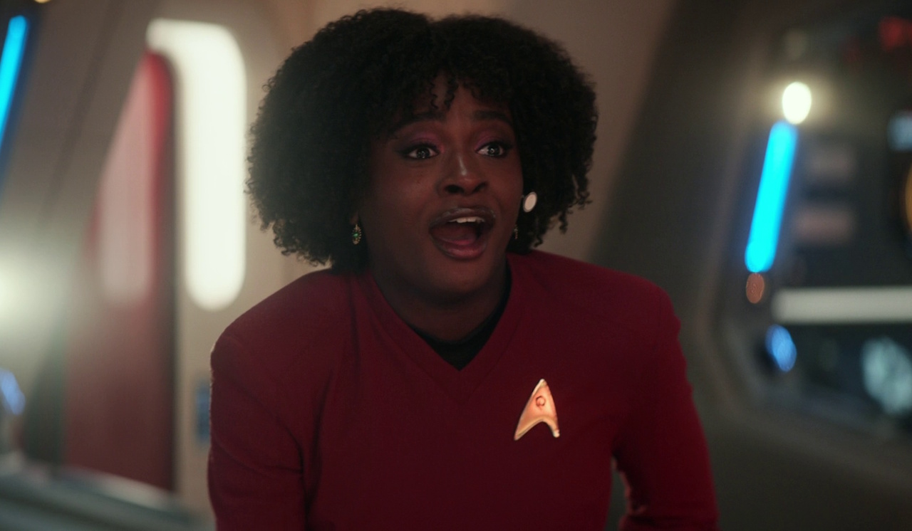 Still frame from Star Trek: Strange New Worlds 3x09: Terrarium, showing Uhura on the bridge, happy.