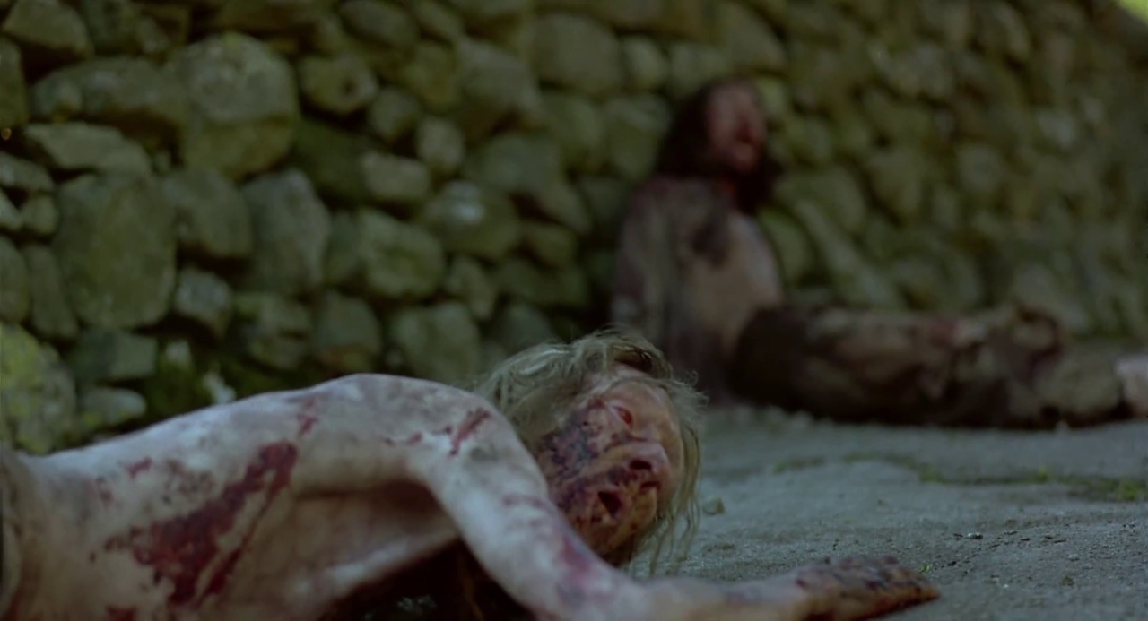 Still frame from 28 Days Later showing two zombies dying.
