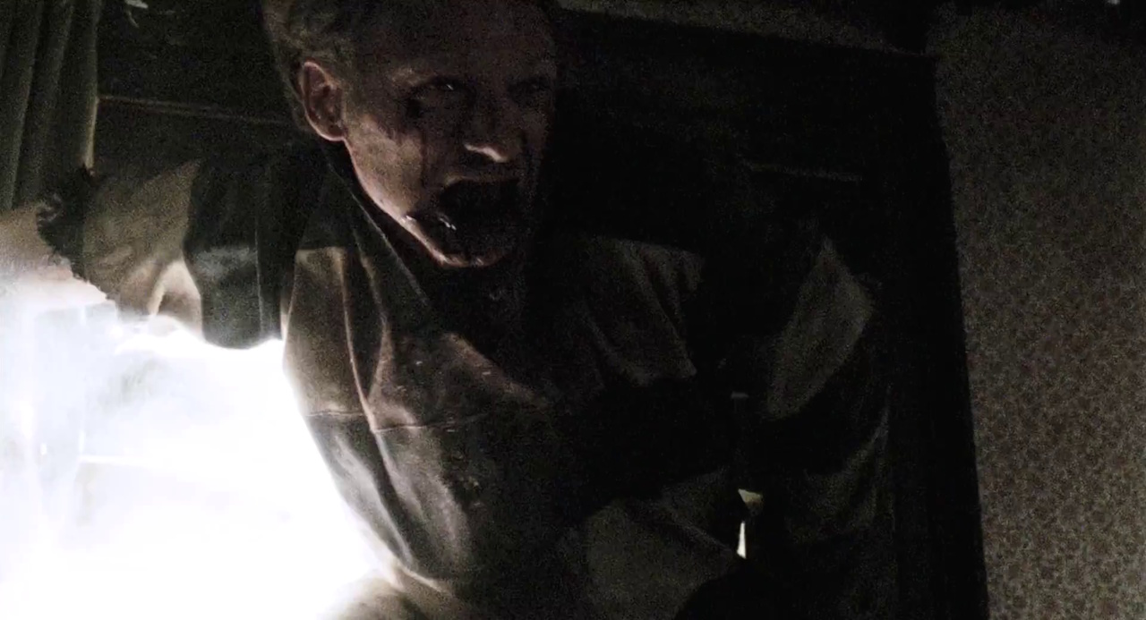 Still frame from 28 Weeks Later showing a zombie breaking in through a window.