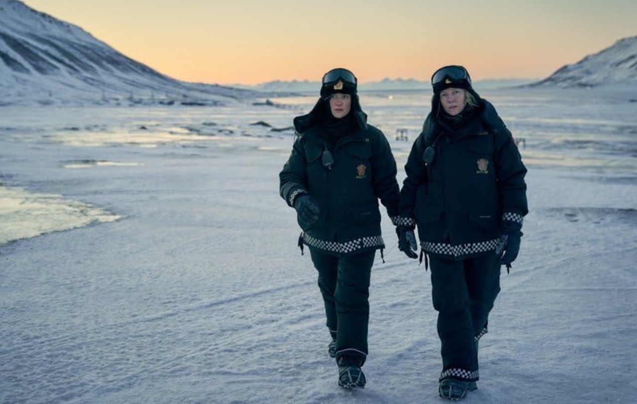 Still frame from Fortitude (2015) showing two female police officers walking across an icy landscape.