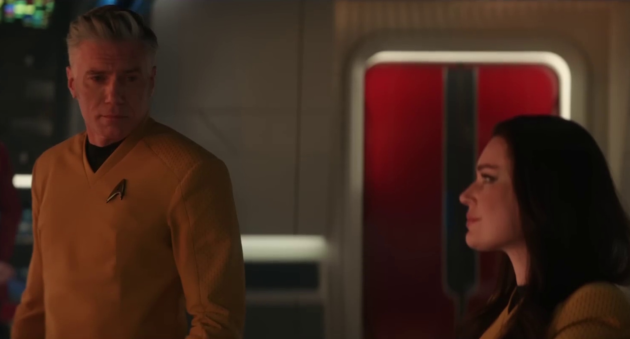 Still frame from the Star Trek: Strange New Worlds Season 4 promo clip showing Pike and Una on the bridge.