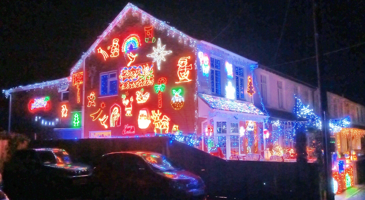 Photo of a house adorned with many Christmas lights and ornaments.