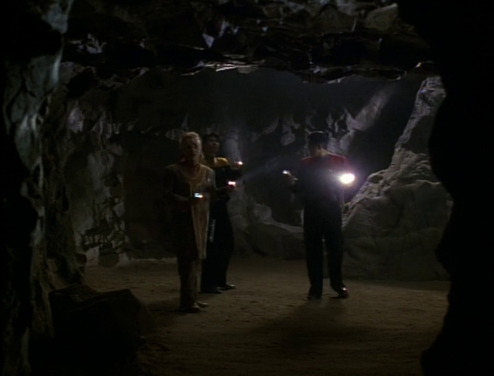 Still frame from Star Trek: Voyager showing an away mission to a cave.